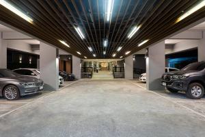 a garage with two cars parked in it at Ploen Place Residence in Pattaya Central