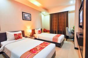 Krevet ili kreveti u jedinici u objektu Daima Hotel Padang
