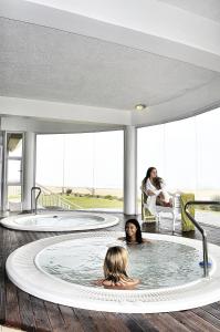 two people in a hot tub in a house at SeaSide Hotel & Spa in Swakopmund