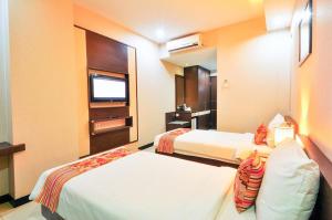 Krevet ili kreveti u jedinici u objektu Daima Hotel Padang