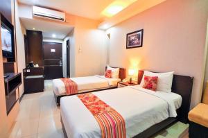 Krevet ili kreveti u jedinici u objektu Daima Hotel Padang