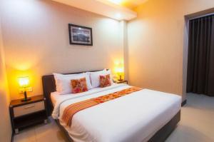Krevet ili kreveti u jedinici u objektu Daima Hotel Padang