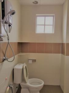 a bathroom with a toilet and a window at Goodlife Paradise @ Imperial Court in Cameron Highlands