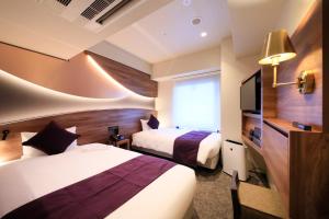 Giường trong phòng chung tại Quintessa Hotel Tokyo Ginza