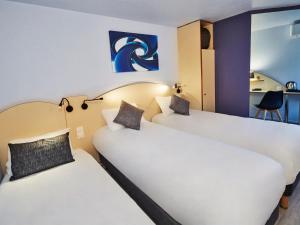 Postel nebo postele na pokoji v ubytování Kyriad Direct Bron Lyon Eurexpo