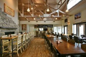 a restaurant with wooden tables and chairs and a bar at Artistic Hillside Loft in Blue Mountains