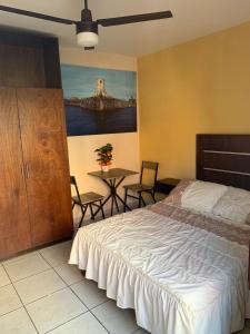 a bedroom with a bed and a table with chairs at Hotel Posada San Juan in Veracruz