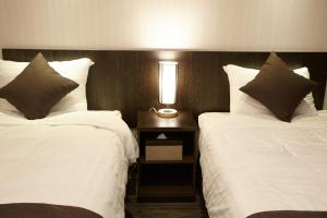Postel nebo postele na pokoji v ubytování CS Premier Hotel