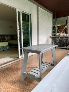 a gray picnic table sitting on a patio at Haadson Resort & Koh Raham in Haad Son