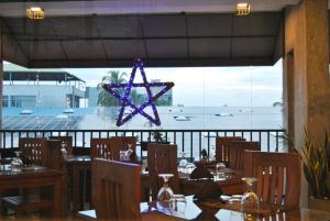 a dining room with a star hanging from the ceiling at The Canoe in Negombo