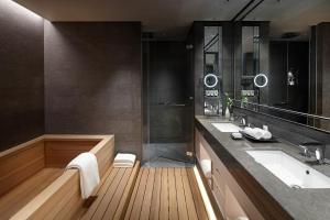 a bathroom with two sinks and a large mirror at Signiel Seoul in Seoul