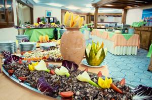 a tray of food on a table with a vase at Club Parco Blu in Cala Gonone