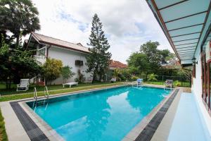 a swimming pool in front of a house at Lioni Holidays Villa in Negombo