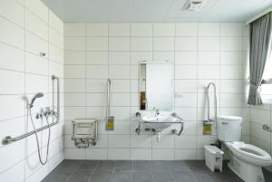 a bathroom with a sink and a toilet at 客旅家青年旅館 Travelers Plus in Chiayi City +28 photos