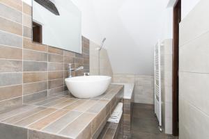 a bathroom with a white tub and a sink at House 54 in Braşov +18 photos