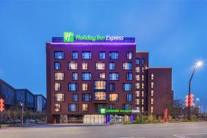 a building with a sign on the top of it at Holiday Inn Express Beijing Shijingshan Lakeview, an IHG Hotel in Beijing