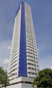 a tall skyscraper with a blue building at Essencial Manaíra in João Pessoa
