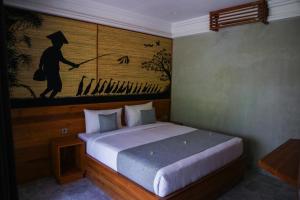 Postel nebo postele na pokoji v ubytování De Rekun Ubud