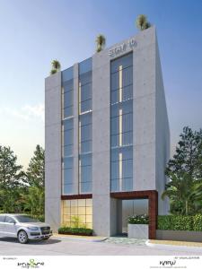 un edificio con un coche aparcado delante de él en Stay10 Studio Apartments en Indore