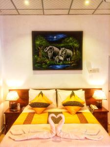 a bedroom with a bed with a painting on the wall at Empire Valley Hotel in Kandy