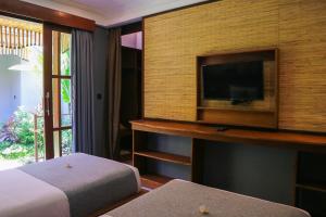 Postel nebo postele na pokoji v ubytování De Rekun Ubud