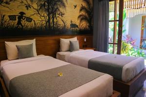 Postel nebo postele na pokoji v ubytování De Rekun Ubud