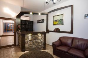 ein Wohnzimmer mit einem Sofa und einem Steinkamin in der Unterkunft Pamporovo Central Apartments in Pamporowo