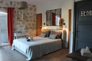 a bedroom with a bed and a mirror and a door at Au Pied des Baous in Vence