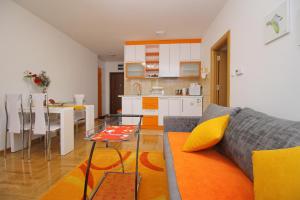 a living room and kitchen with a couch and a table at Apartment Jony Lux Center in Zlatibor