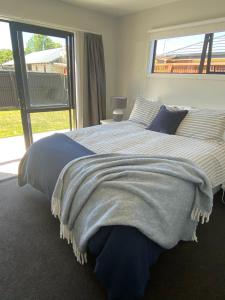 a bedroom with a bed with a blanket on it at Central Retreat and self contained with free wifi in Cromwell