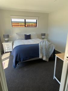 a bedroom with a large bed with a window at Central Retreat and self contained with free wifi in Cromwell