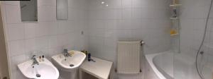 a bathroom with a sink and a toilet and a tub at Le dernier métro in Brussels