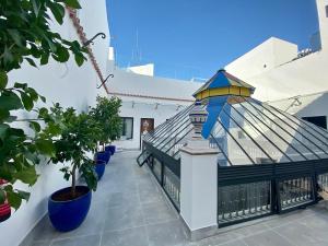 a balcony of a white building with a roof at Soho Boutique Sevilla in Seville