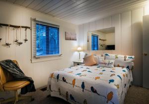 a bedroom with a bed and a chair and a mirror at 43 The Last Resort in Wawona