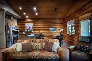 a living room with a couch and a kitchen at 38 The Mini Cabin in Wawona