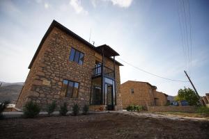a brick house with a large window at Gnishik Eco Lodge in Gnishik