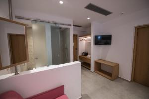 A television and/or entertainment center at Natura Luxury Boutique Hotel Skopelos