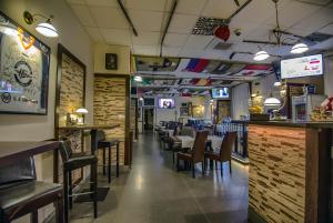 a restaurant with tables and chairs and a bar at Penzión Sport in Košice