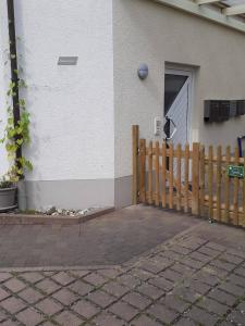 a house with a wooden fence and a door at Zimmer Frei 2 in Wiesbaden