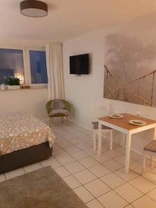 ein Hotelzimmer mit einem Bett, einem Tisch und einem Tisch in der Unterkunft Zimmer Frei 2 in Wiesbaden