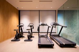 a gym with cardio equipment in a hotel room at Keio Prelia Hotel Sapporo in Sapporo