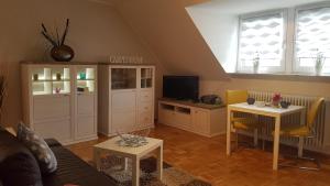 a living room with a couch a table and a tv at Ferien-& Monteurwohnung Koenen2 nah am Westfield Centro in Oberhausen