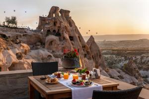 a table topped with a plate of food at Argos in Cappadocia in Uçhisar