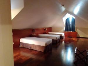 Tempat tidur dalam kamar di Hotel Acez