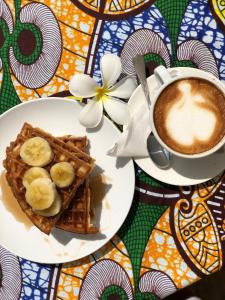 a plate of waffles and a cup of coffee at Zanzibar Queen Hotel in Matemwe