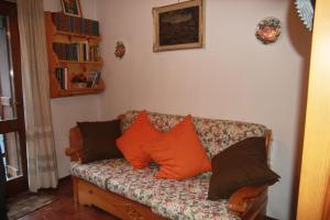 a couch in a living room with pillows on it at L'Atelier du Temps - La Petite maison de Pepa in La Salle