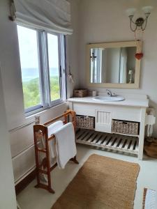a bathroom with a sink and a mirror at Kangela 11 in Ponta Malongane