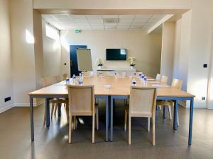 a conference room with a large wooden table and chairs at Best Western Hôtel Journel Antibes Juan-les-Pins in Antibes