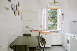 a white kitchen with a table and chairs at 010 - Sant Anna loft VISTA MARE 150m dalla SPIAGGIA in Sestri Levante