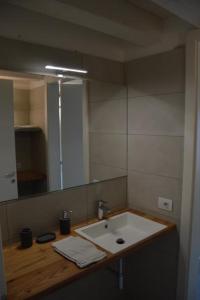 a bathroom with a sink and a mirror at Dimora Sannicolò - Talento in Rovereto